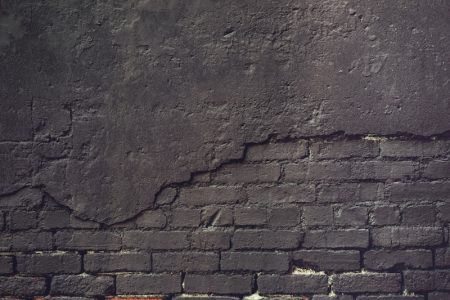 an old brick wall with a grungy surface
