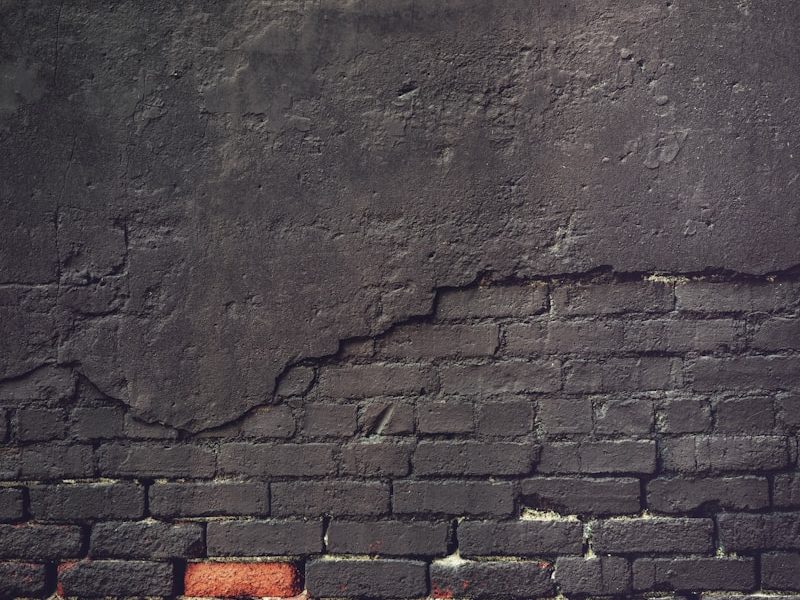 an old brick wall with a grungy surface